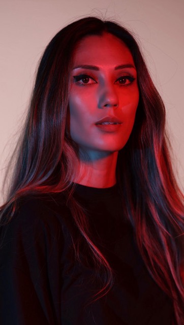 Female DJ artist with dramatic red lighting close-up